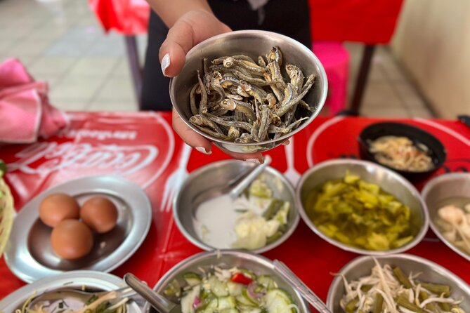 Phuket Old Town Food Tour with 10+ Locals' Favorites Tastings - Looking up from the plate at Sino-Portuguese streets