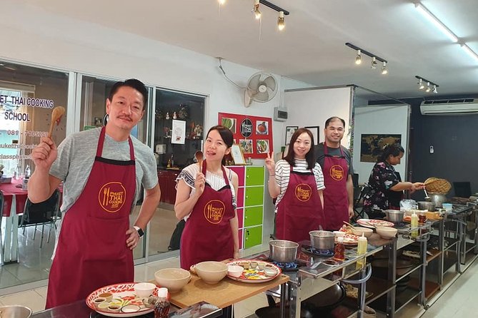 Thai Cooking Class with Market Tour in Phuket by VJ - Making curry paste with a mortar and pestle